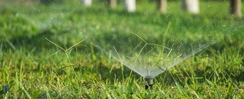 WaterAid Solution sprinklers on green grass